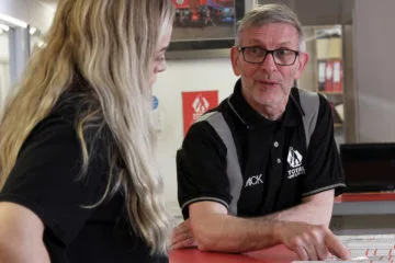 Two total hire sales colleagues in discussion