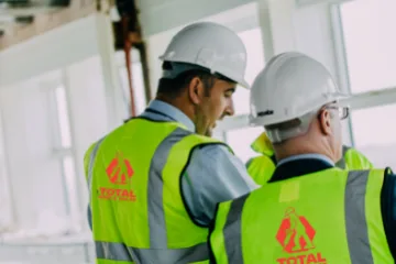 Image of two Total Hire Sales employees in hardhats in discussion